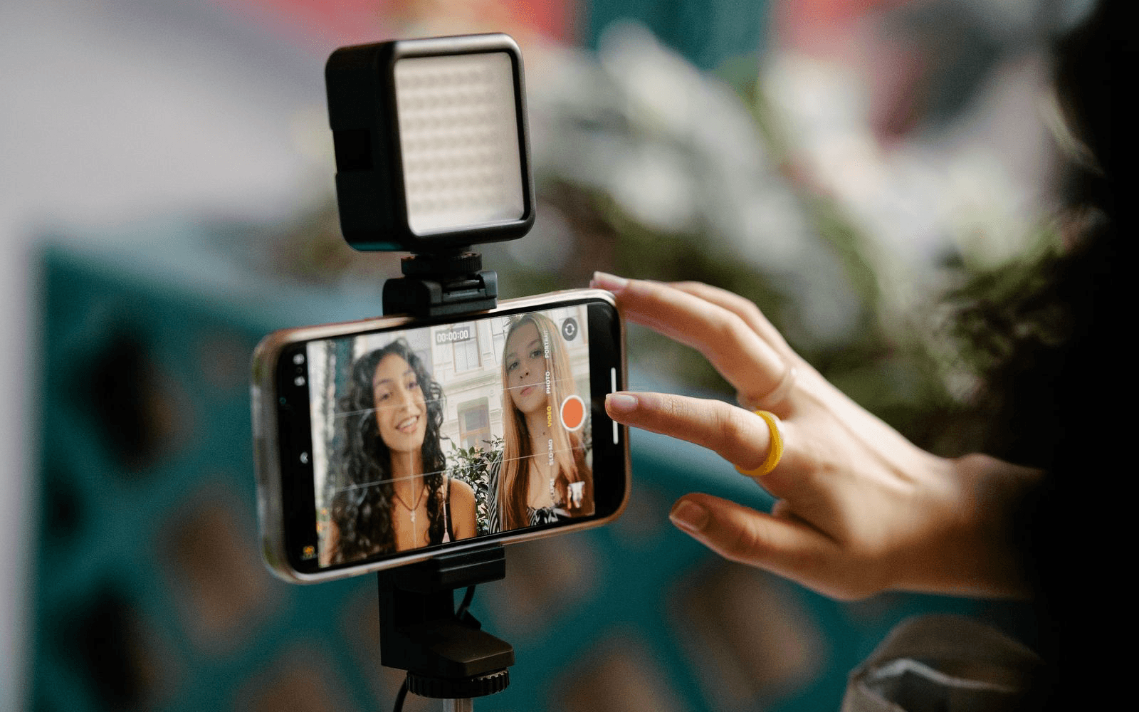 A phone recording two friends making a video together